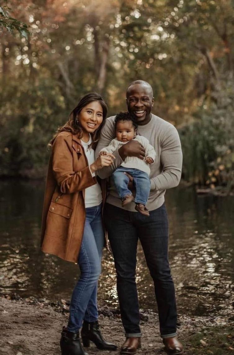 Parents holding newborn in park
