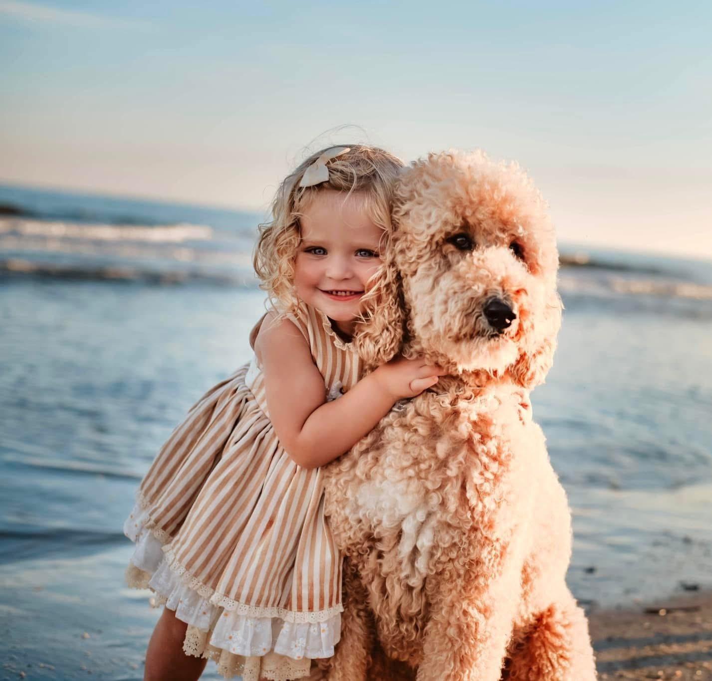 Child hugging dog